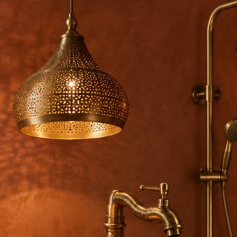 Pierced brass pendant light with intricate openwork pattern